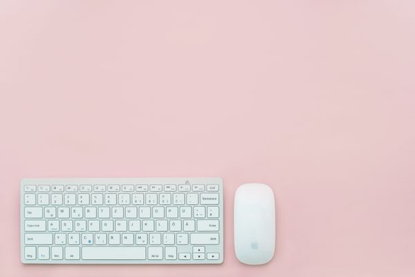 Keyboard and mouse on a large desk pad