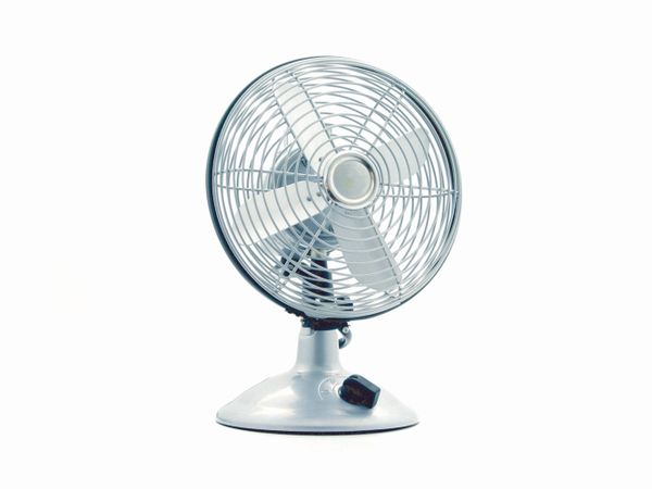 A small desk fan on a table
